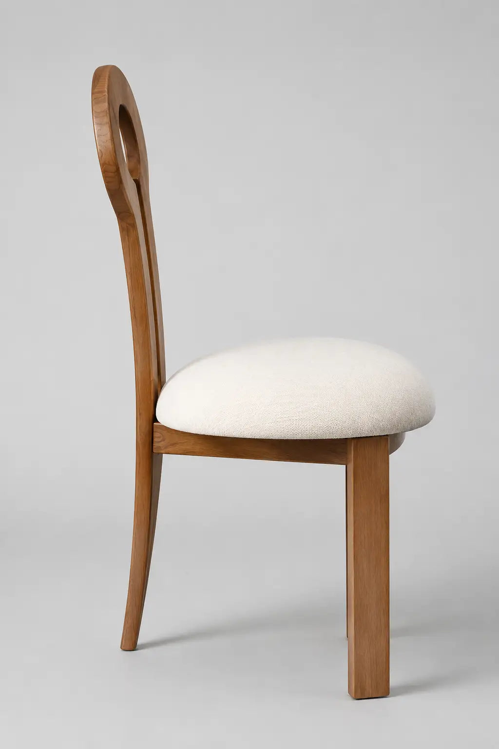 Mid-century wooden dining chair with keyhole backrest, rounded upholstered seat and light walnut finish, side profile