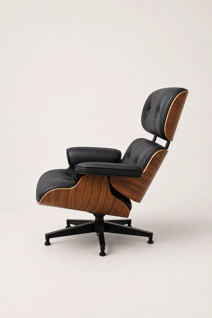 Front three-quarter view of black leather office lounge chair with tufted cushions and walnut shell