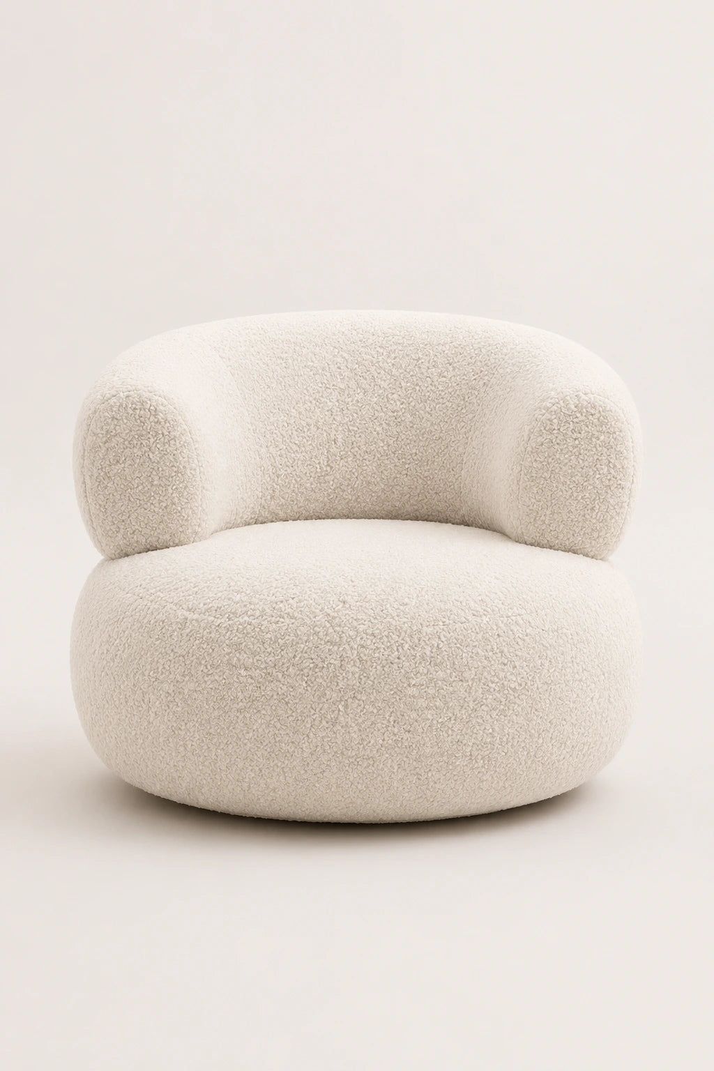 White bouclé armchair angled studio view with curved arms and rounded silhouette