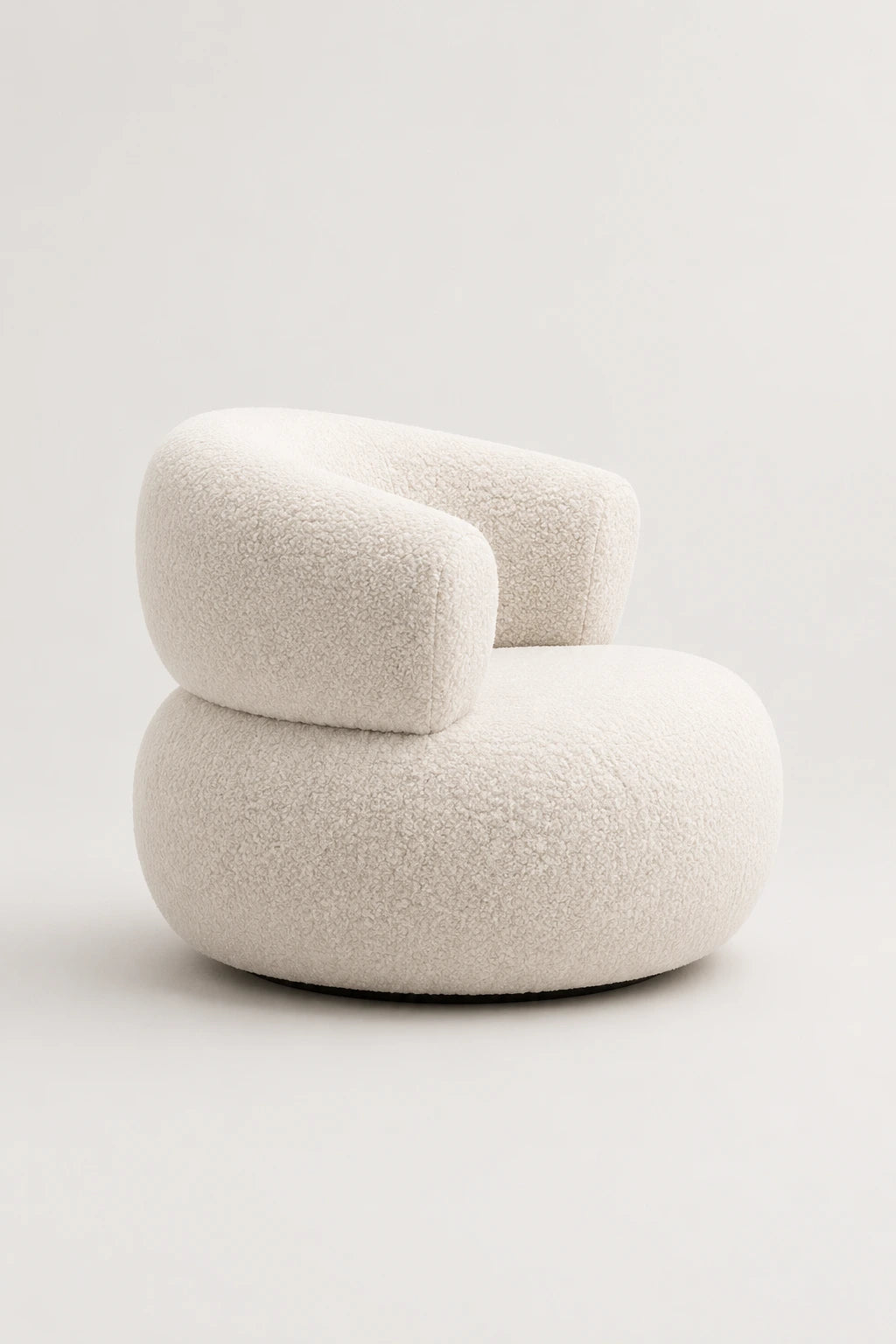 White bouclé armchair front view with rounded back and sculptural seat