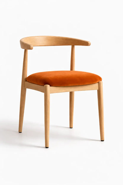 Modern Scandinavian dining chair with natural oak frame and burnt orange velvet seat cushion, front view on neutral studio background.