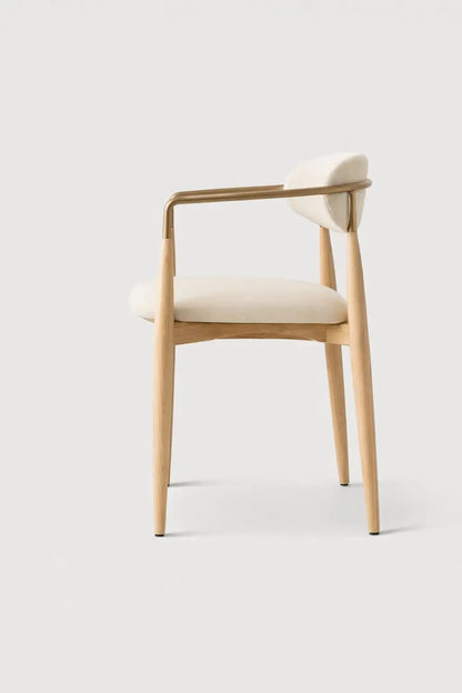 Modern ash dining chair UK side view with solid wood frame and upholstered seat on neutral studio background.