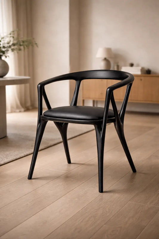 modern dining chair UK with black wooden frame and upholstered cushion minimalist studio background
