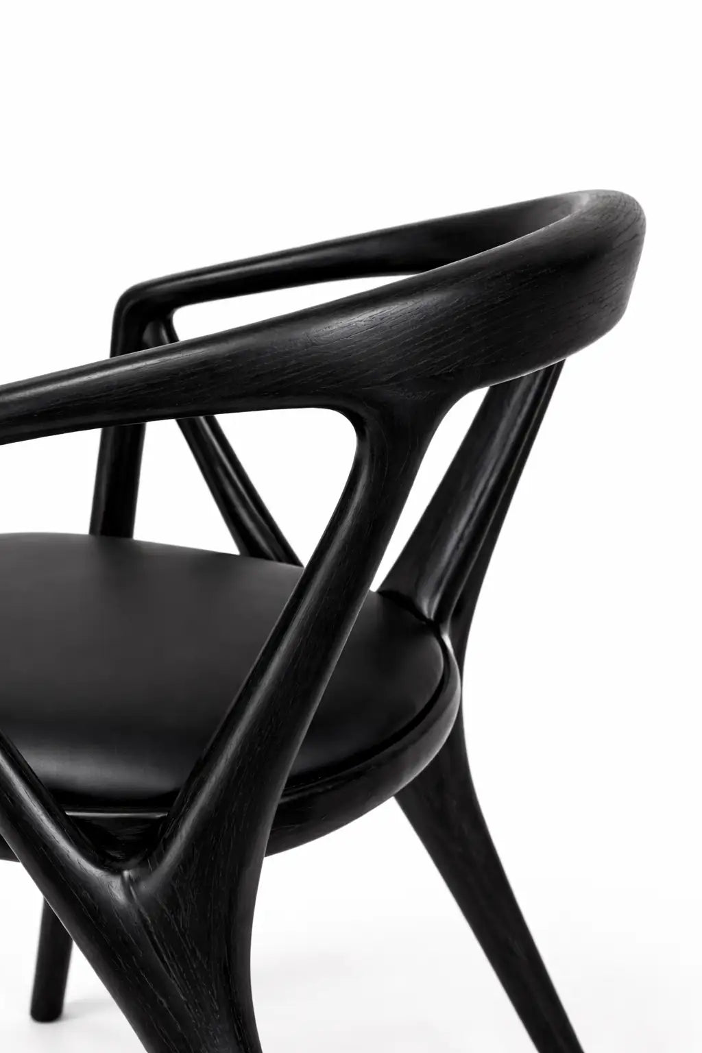 mid century modern chair UK angled view showcasing black wood structure and fabric seat