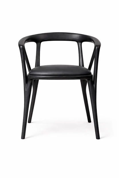 Modern wooden dining chair with curved arms and padded seat, shown at a three-quarter angle