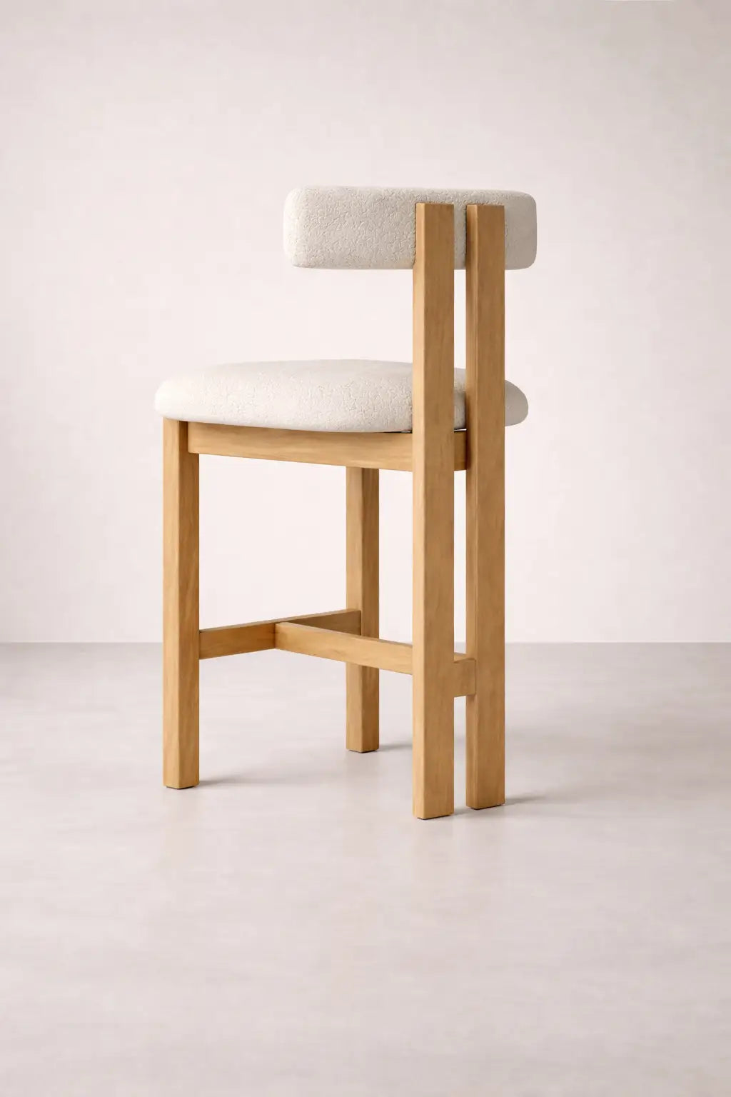 Feltham ash wood bar stool UK 45 degree view, modern wooden breakfast bar stool with textured bouclé upholstery.
