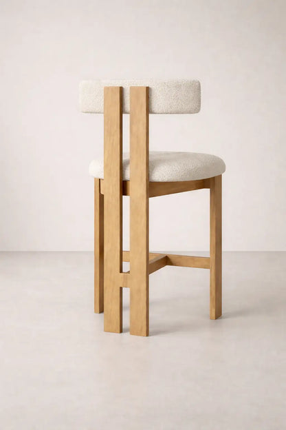 Feltham bar stool UK in solid ash wood with bouclé seat, modern wooden bar stool back view on neutral studio background.