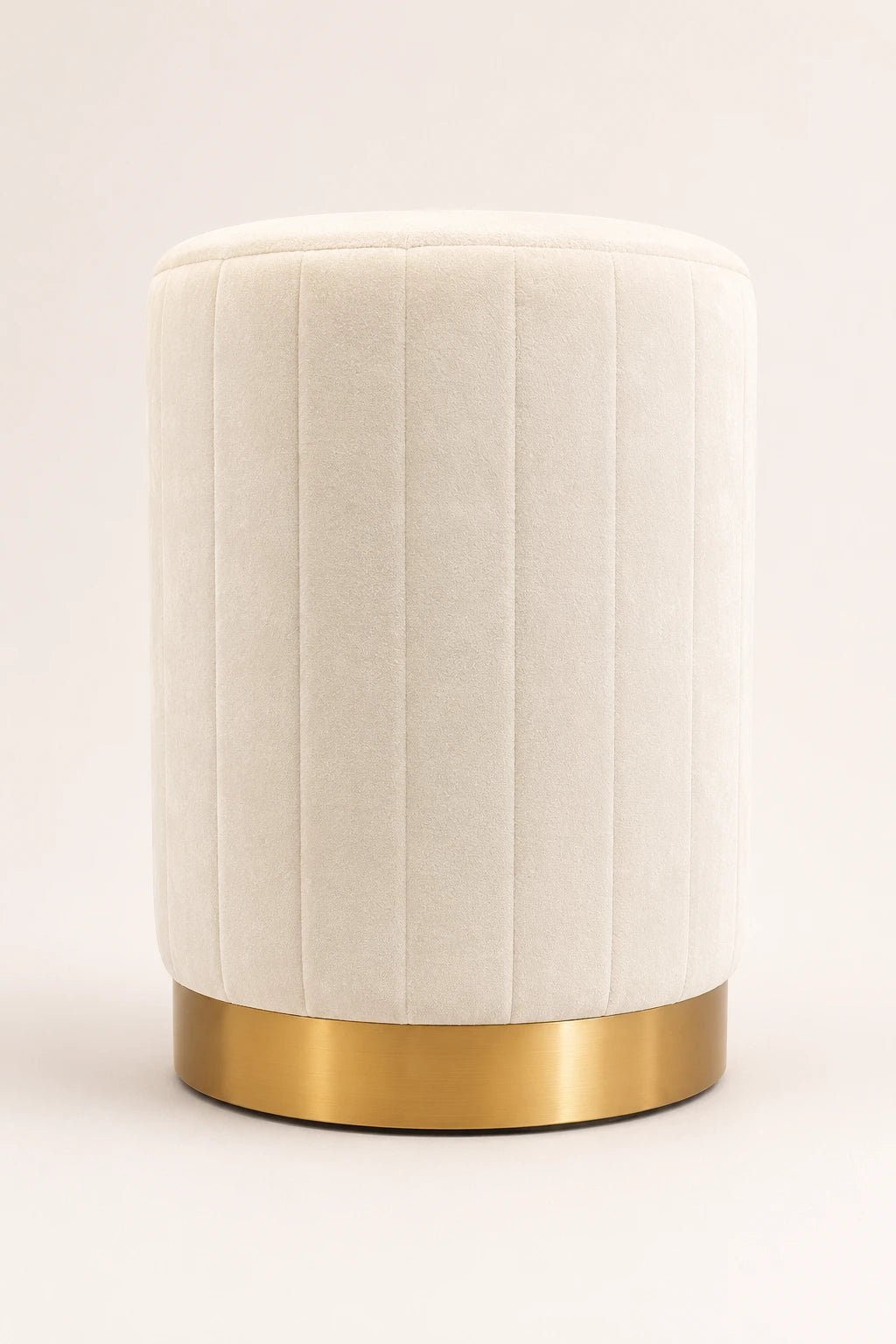 White textured cylindrical stool with a gold base on a light beige background