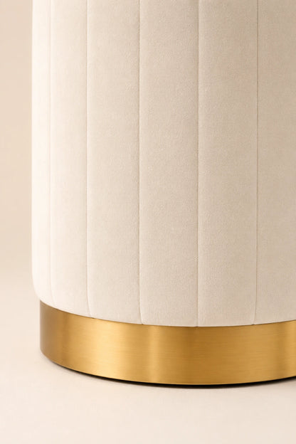 White cylindrical object with a gold base on a beige background