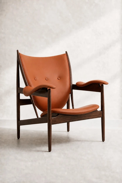 Front-right view of the Kensington cognac leather sling armchair with a dark wood frame