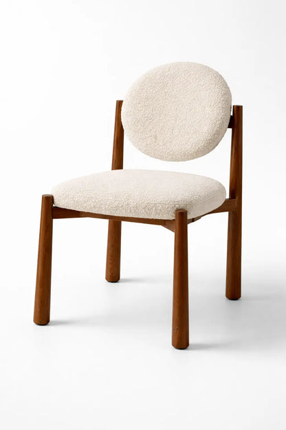 mid century boucle dining chair UK with solid walnut frame and cream upholstered seat front view studio background