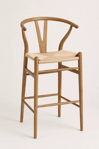 Wooden bar stool with a woven seat on a white background
