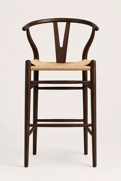 Wooden bar stool with woven seat on a white background