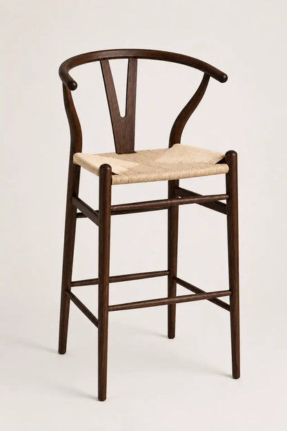 Wooden bar stool with a woven seat on a white background