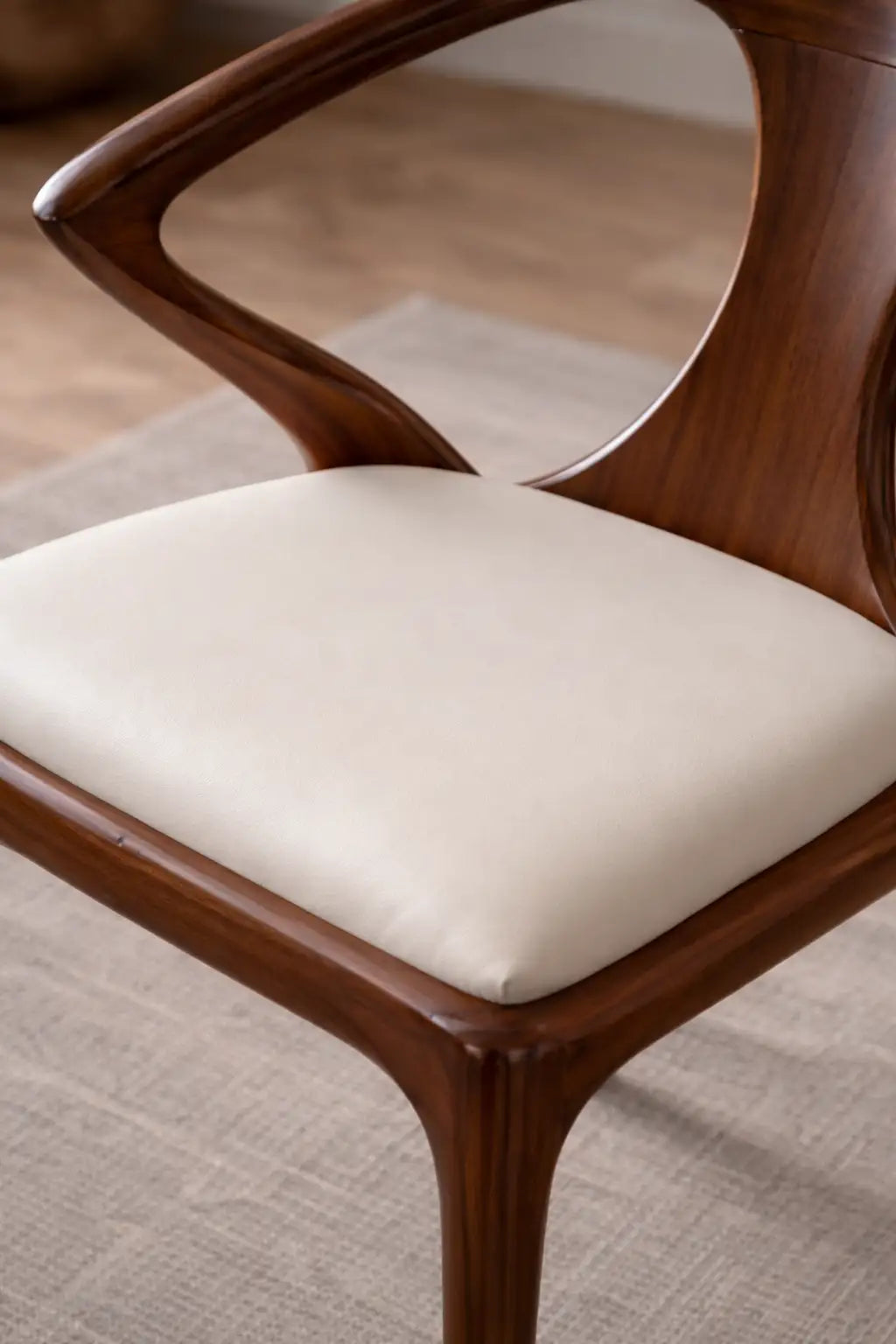 Wooden chair with a white cushion on a textured surface