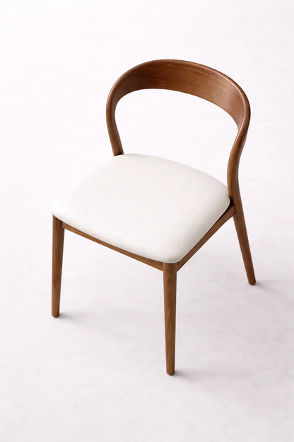 Wooden chair with white cushion on a white background
