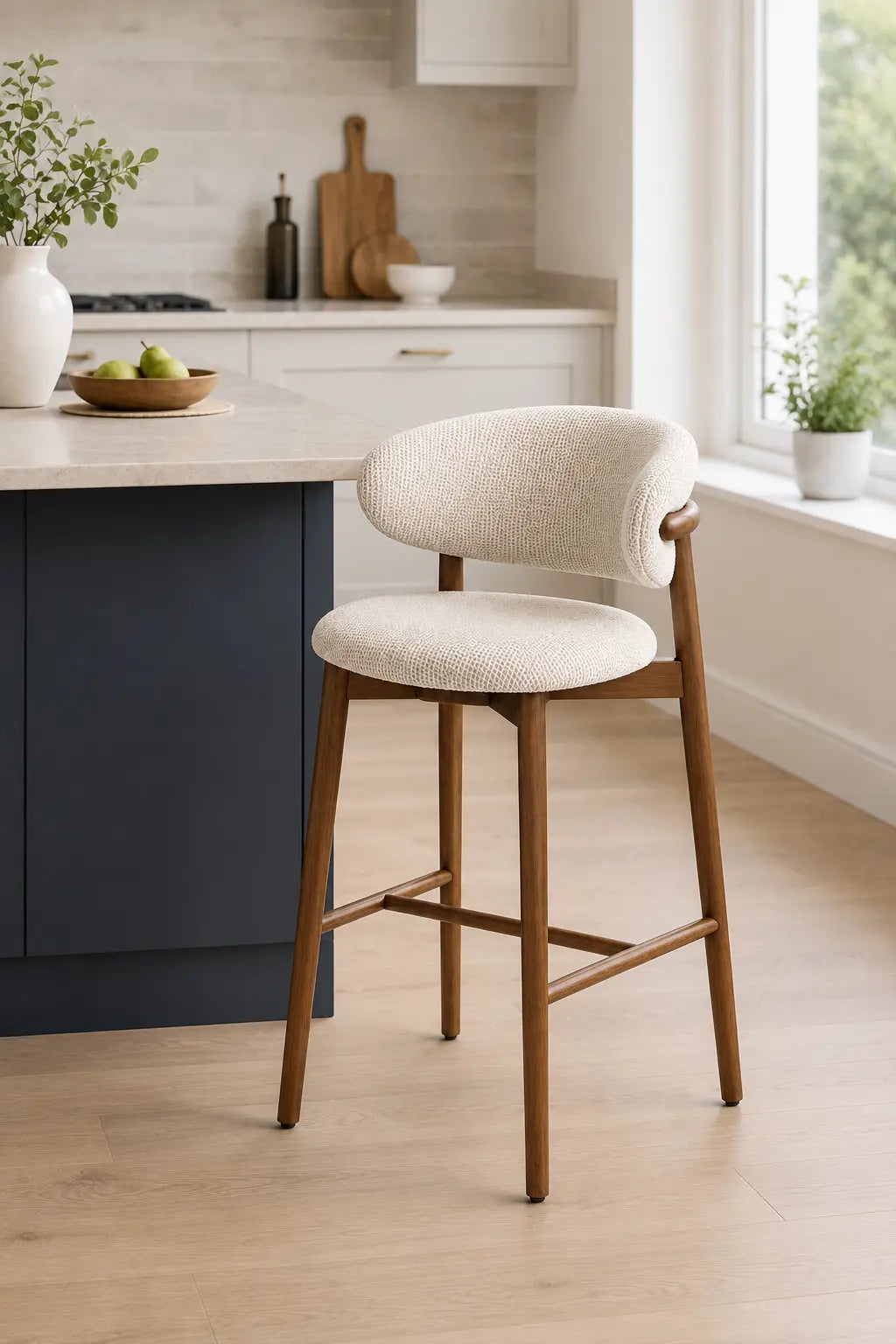 Modern wooden bar stool with textured cream seat next to kitchen island in a UK home kitchen