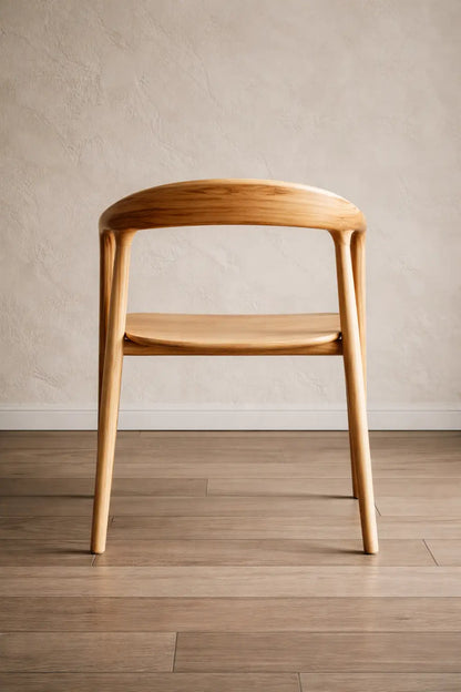 Front view of a minimalist Scandinavian dining chair UK, crafted in natural wood for café seating and restaurant dining spaces.