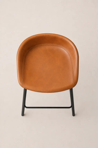 Brown leather chair with black metal legs on a beige background