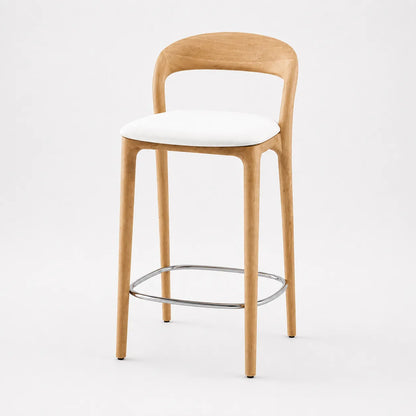 Angled view of a wooden kitchen island bar stool with curved oak-colour backrest, white seat and polished metal footrest