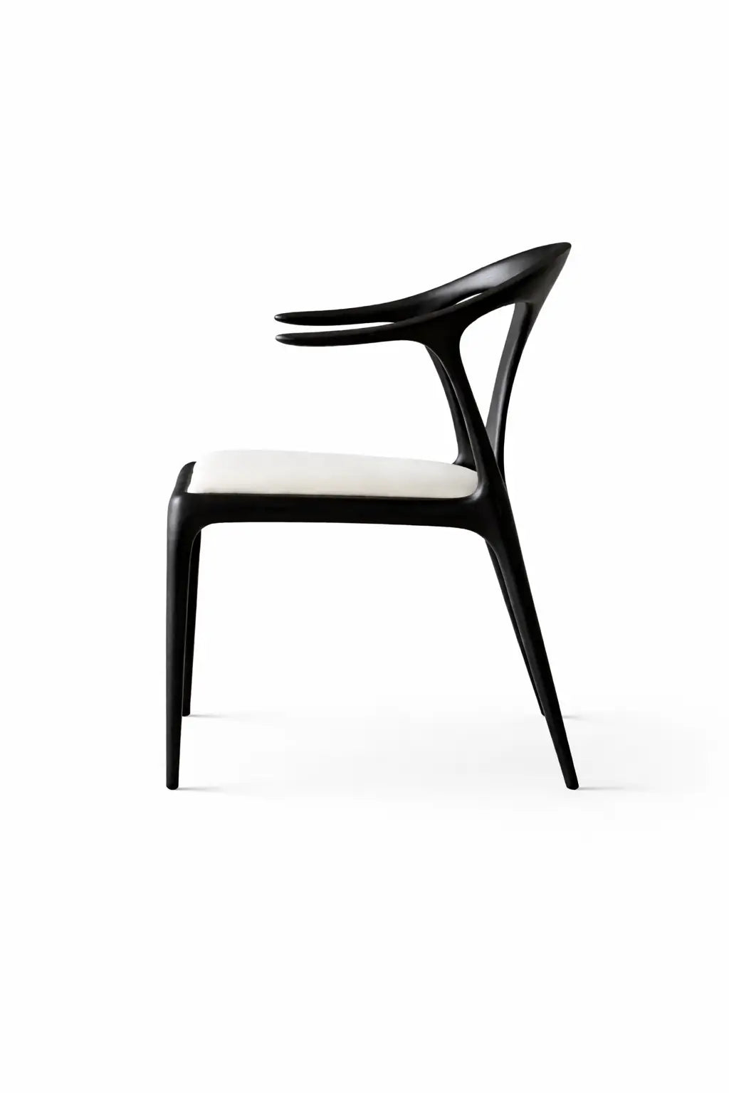 Side profile of modern black dining chair with solid wood frame and cream cushion, contemporary UK dining furniture.