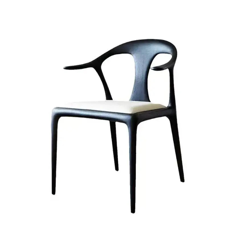 Black sculptural dining chair shown at 45 degree angle with upholstered seat, stylish wooden dining chair UK.
