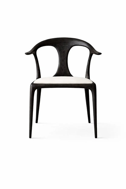 Front view of black wooden dining chair with sculpted backrest and cream upholstered seat on white background.