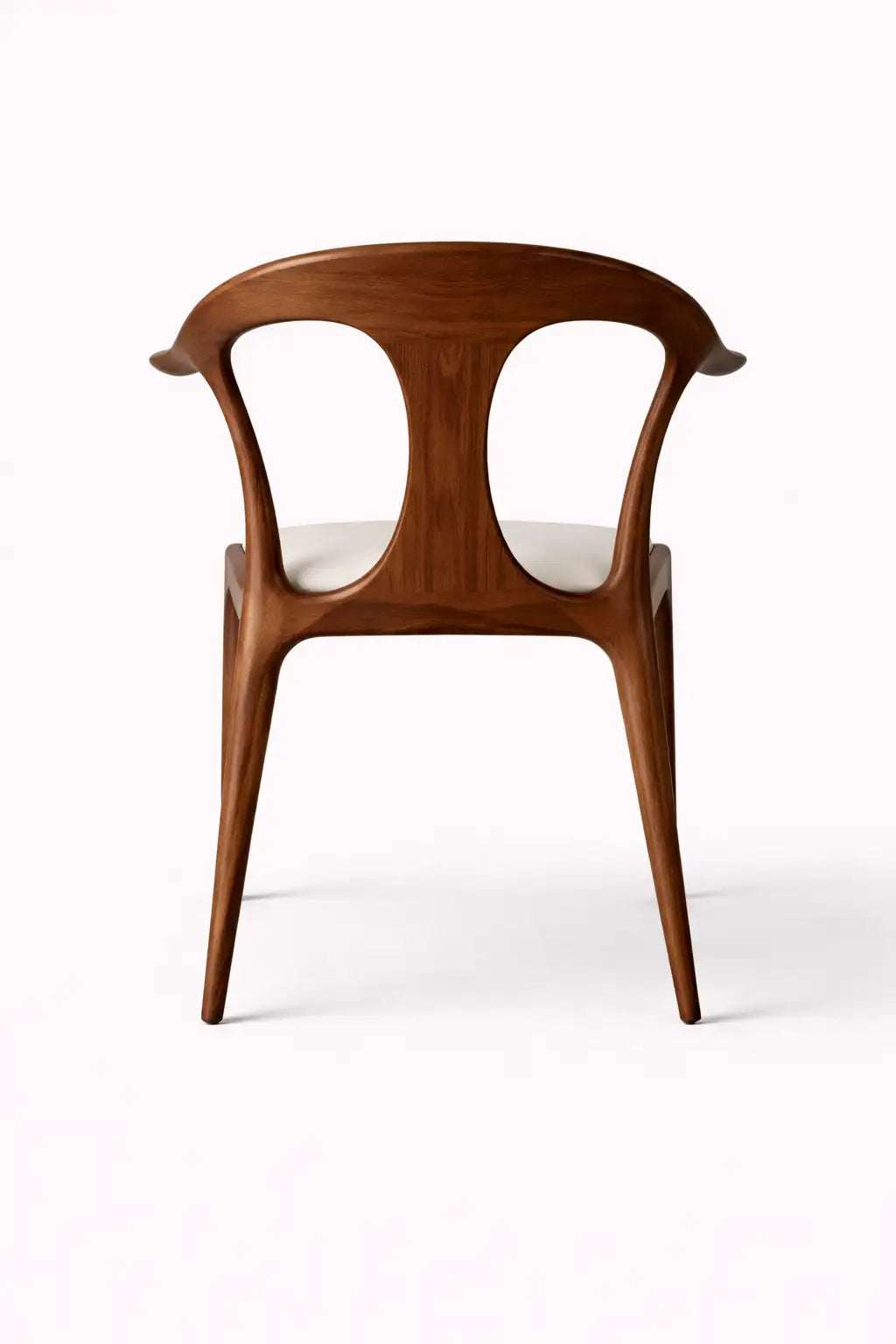 Back view of sculptural walnut dining chair with open backrest design, modern architectural dining chair UK.