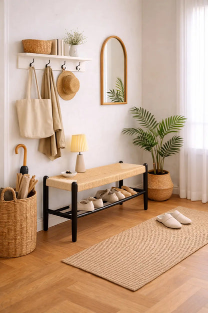 Wooden entryway bench with woven seat and shoe rack for hallway organisation.