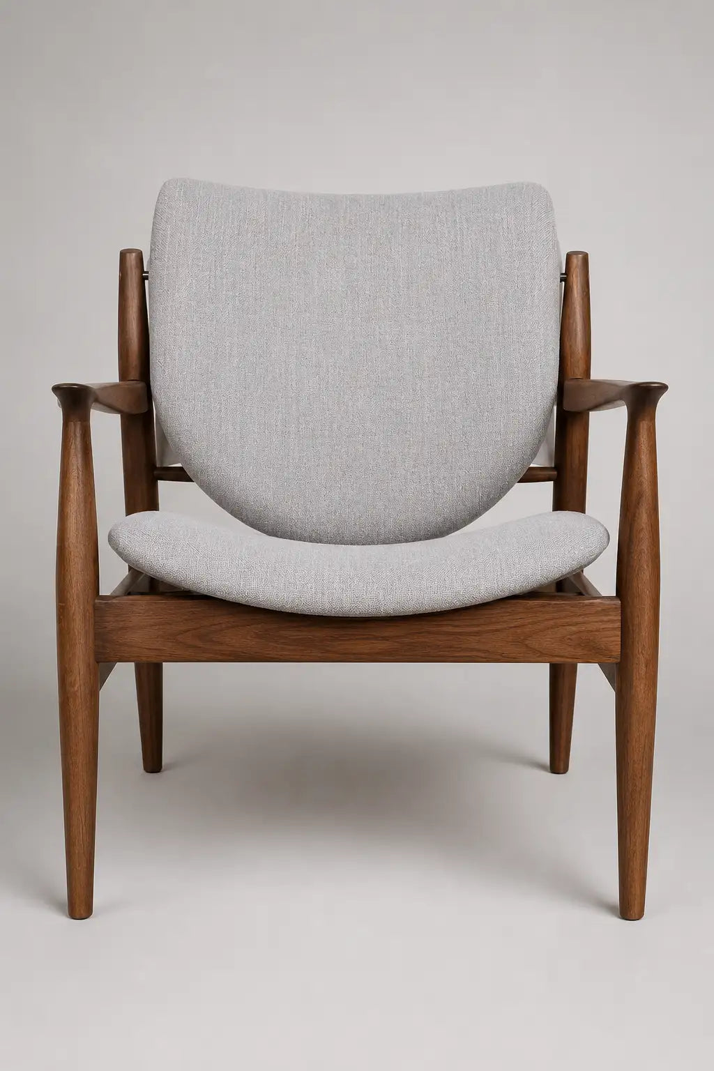 Mid-century walnut lounge chair with upholstered seat and back in a modern neutral living room