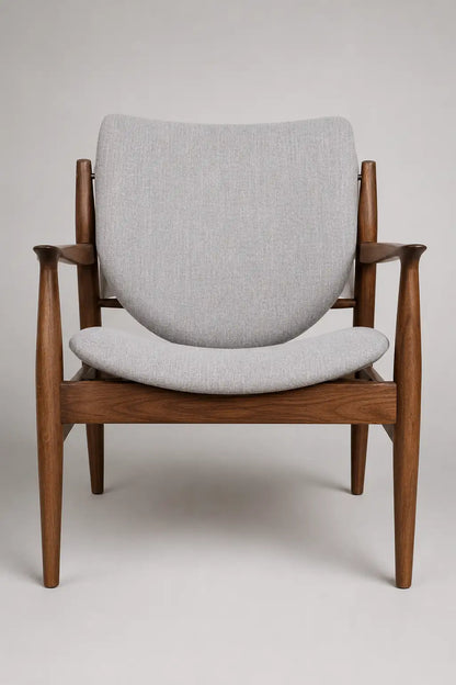 Mid-century walnut lounge chair with upholstered seat and back in a modern neutral living room
